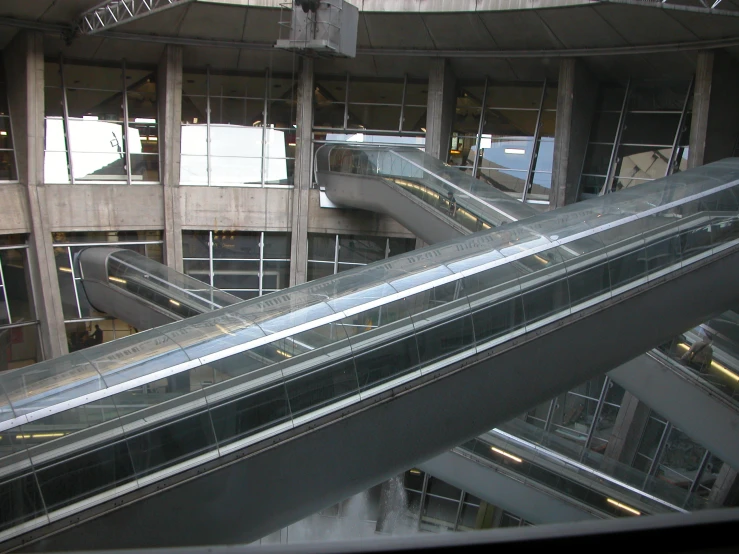 an escalator in a building with windows below