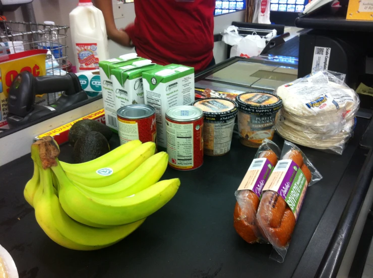 a counter in a grocery store has some bananas on it