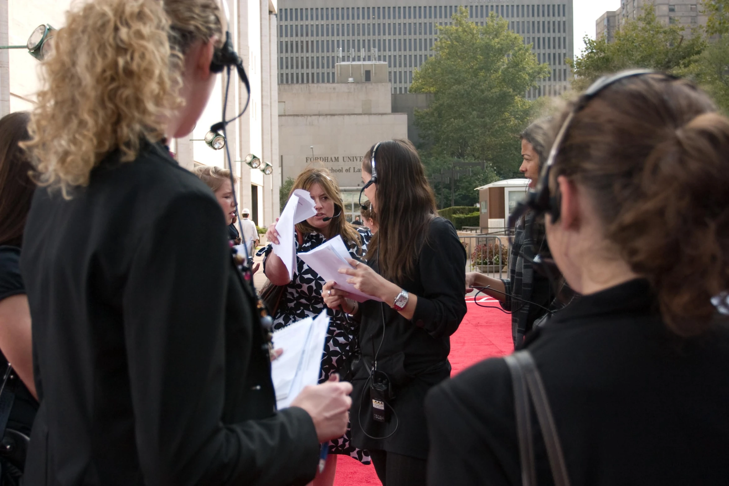 some people on a red carpet talking and having their picture taken