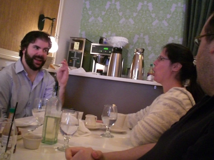 people sitting at a table with some food