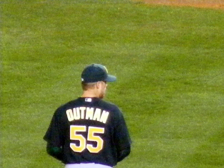 a baseball player in uniform on the field