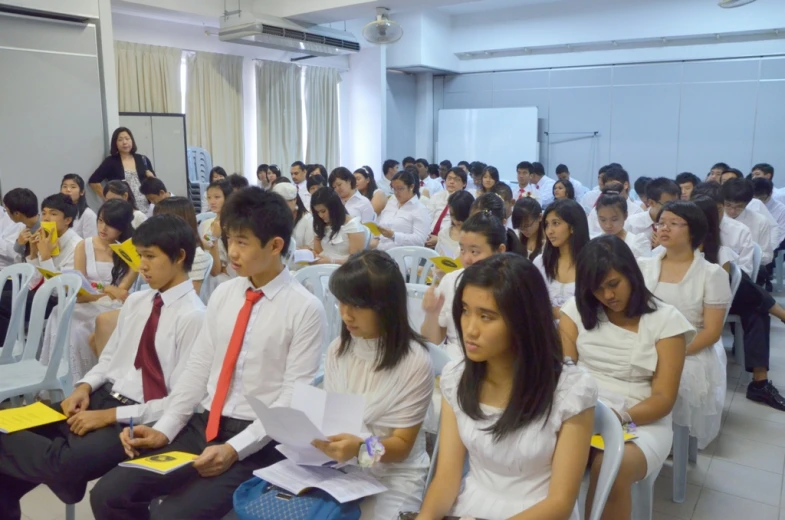 people sitting and waiting in an assembly room