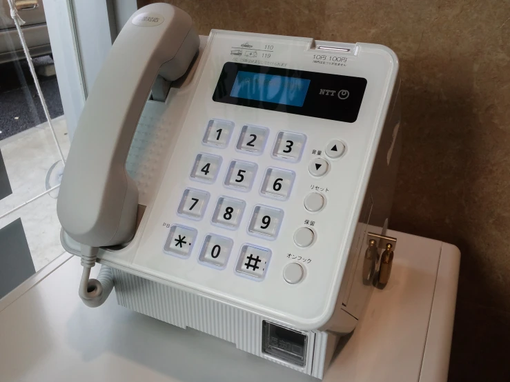an old fashioned rotary phone with a digital dial