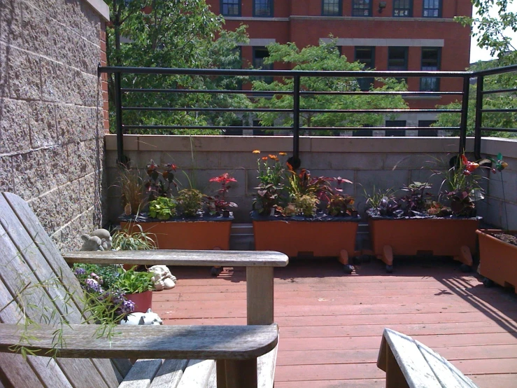 a wood bench sitting on top of a hard wood deck