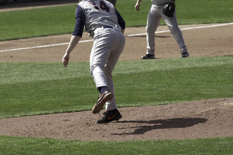 a baseball player on the mound, getting ready to pitch a ball