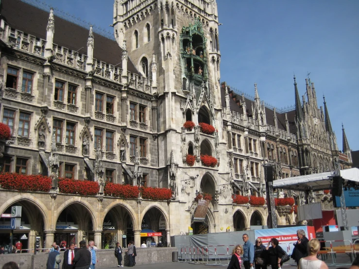 tourists walking through a courtyard in front of a historic building