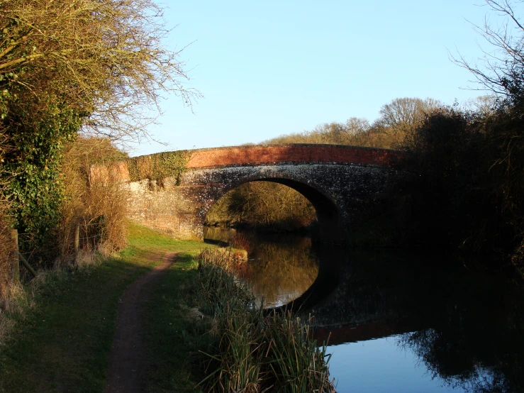 a narrow bridge with a brick overflowing it's width