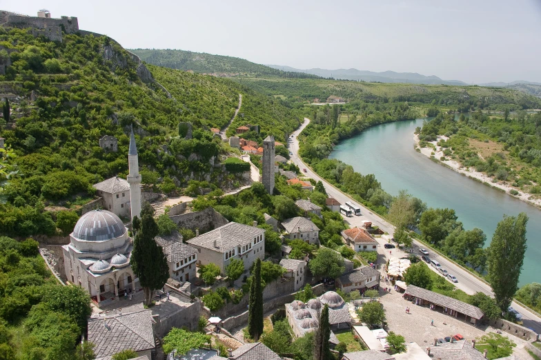 a view of a green valley with a body of water near it