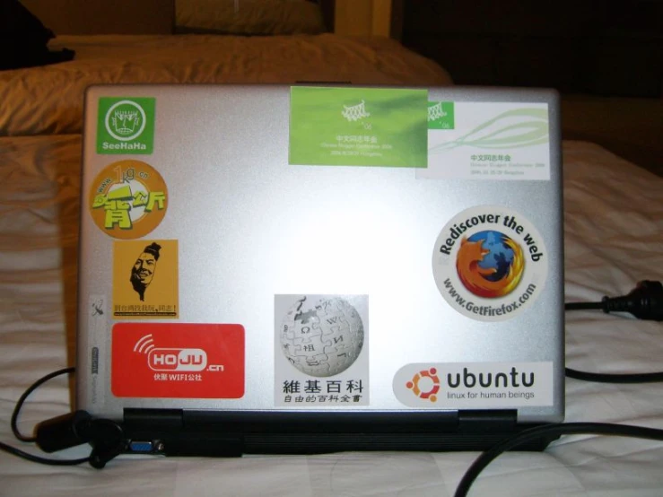 a laptop is decorated with colorful stickers and pictures