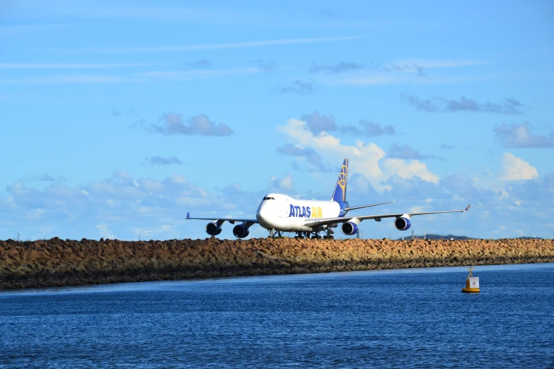 a white airplane is landing at an airport