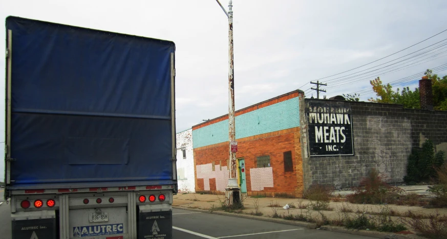 a large truck is riding on the road with other cars in front