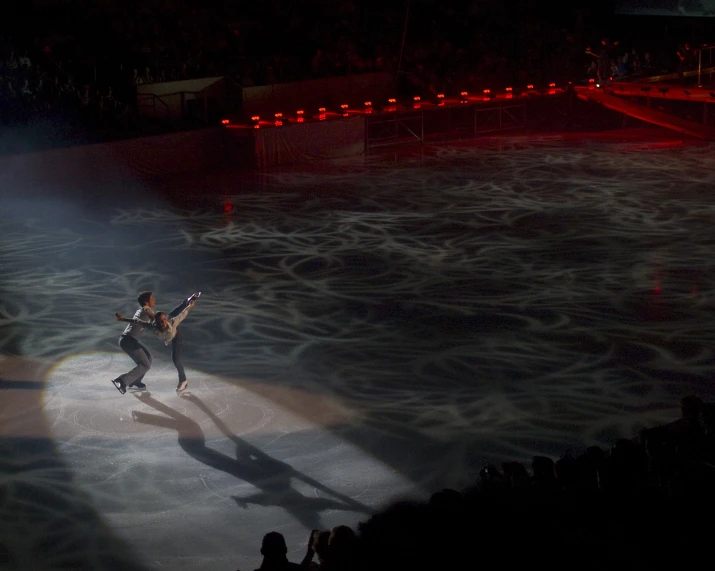 a man is skating alone in an ice rink