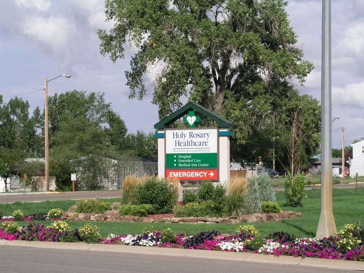 a building and tree are at the entrance to the resort