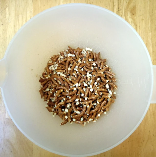 a white bowl full of small brown and white sprinkles