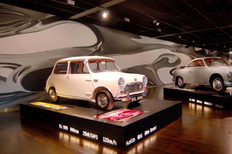 vintage cars and exhibit equipment at a museum