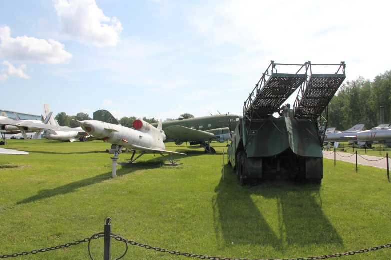 a field with various planes on display at an airport