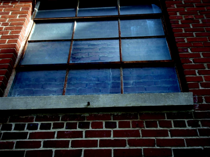 a window on a building has red brick