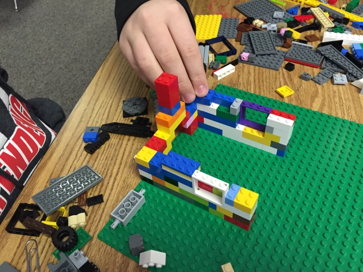 a child is playing with legos while another child watches