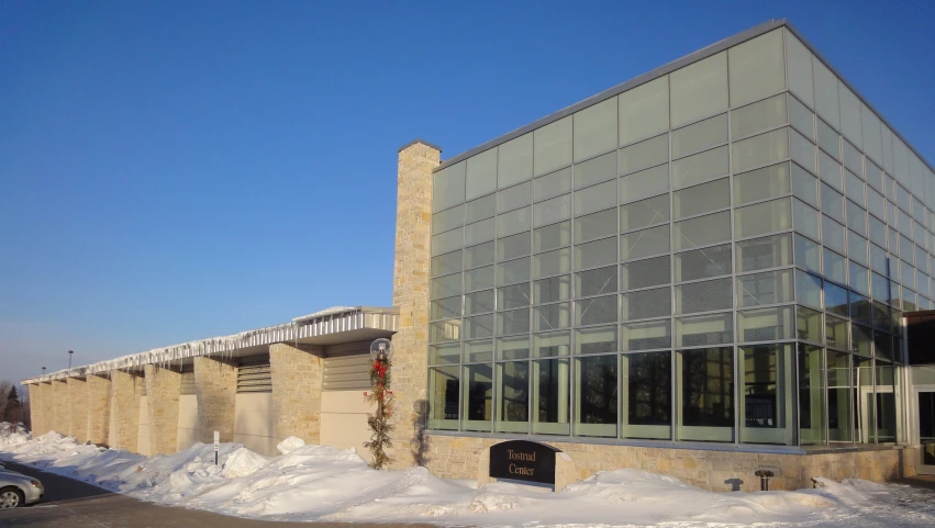 an architectural building with some glass on the front