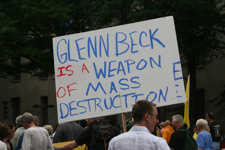 a protest sign in the city that reads glenn beck is a weapon of mass destruction