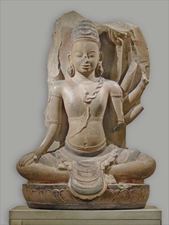 a sculpture of a woman seated in a lotus position