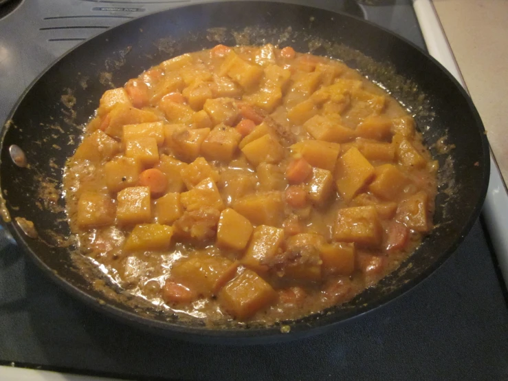 a pan on top of a stove with food inside