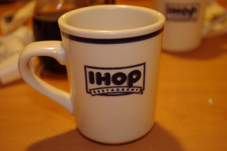 the logo on a coffee mug is black and white