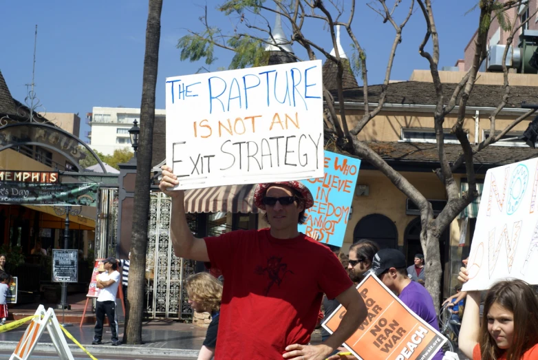 a man is holding a sign on the street