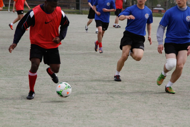 young soccer players are playing with a ball in the field