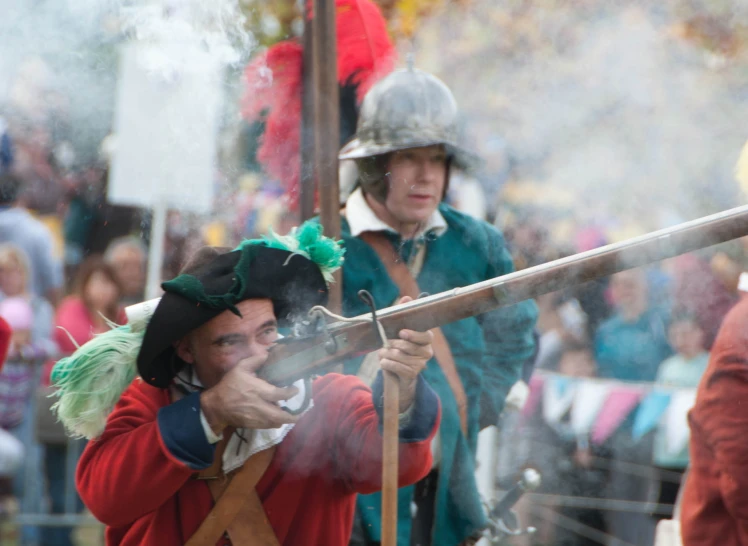 two men in colonial costume, one of them has his helmet on