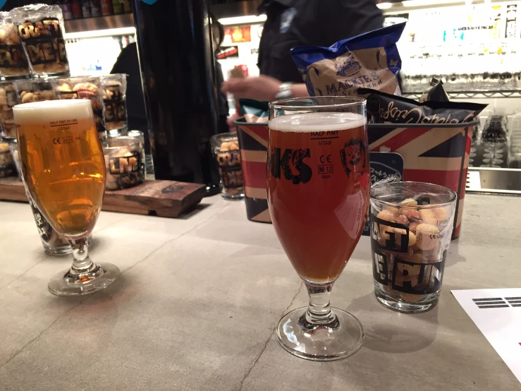 two glasses of beer are placed next to each other