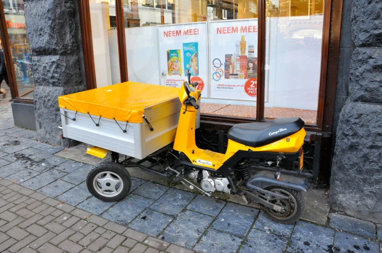 a moped sitting outside of a building on the street