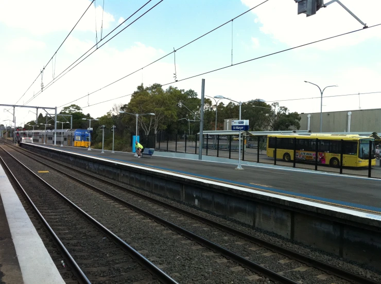 a view of train tracks and a train station with several trains on the track