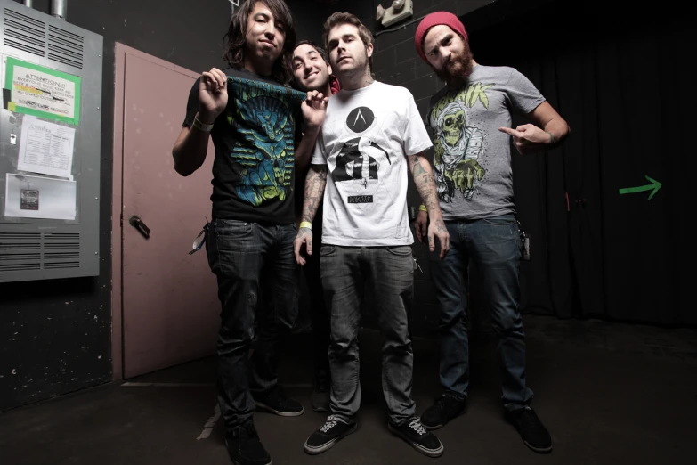 three men wearing different shirts are posing together