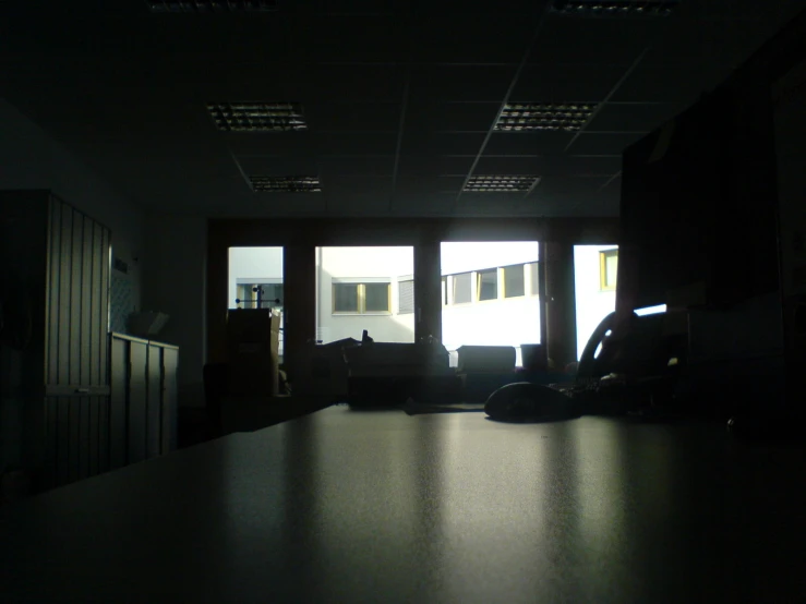 the silhouette of a person sitting in front of a window