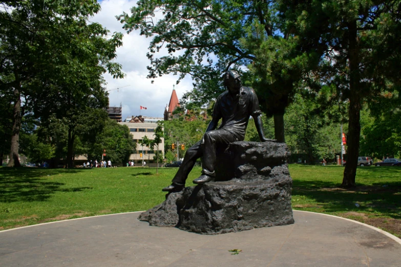 a statue sits in the middle of a park