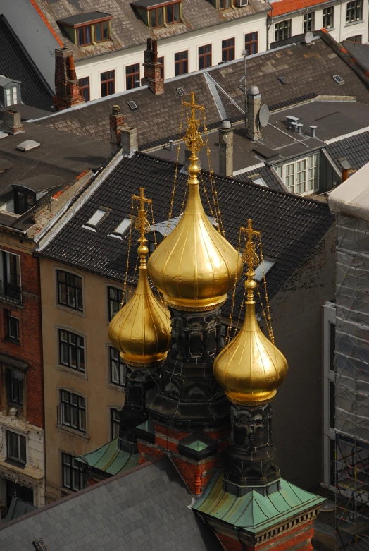 several towers are decorated with golden paint on the top