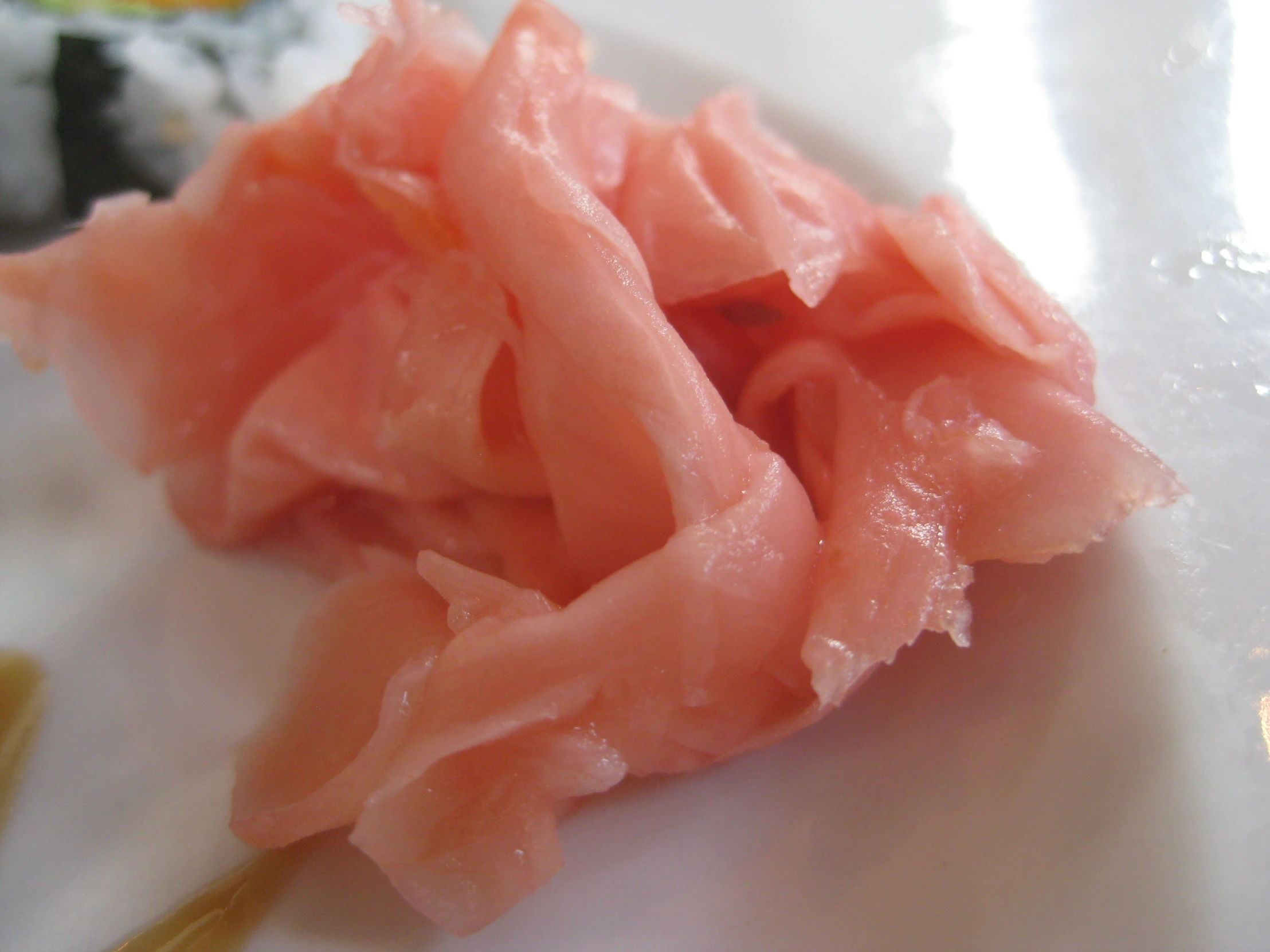 several pieces of raw fish and sushi on a plate