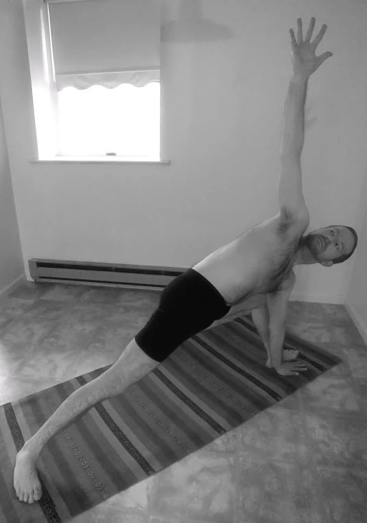 a man is on the floor in his room doing yoga
