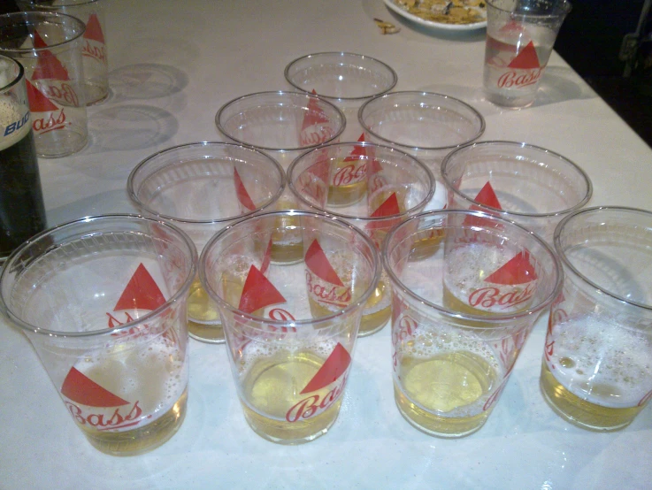 a group of soda glasses sitting on top of a table