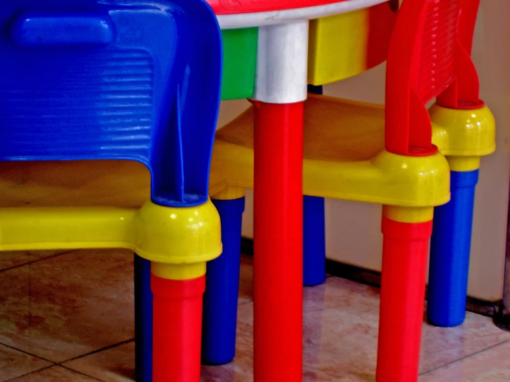 a close up of three children's plastic chairs