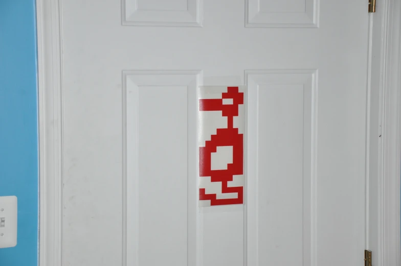 a white door that has stickers and a light switch on it