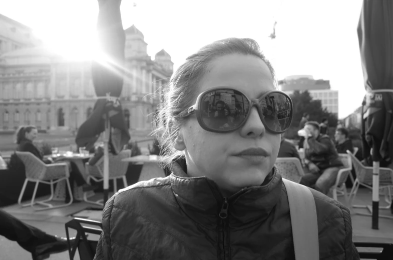 a young woman wearing sun glasses in the city