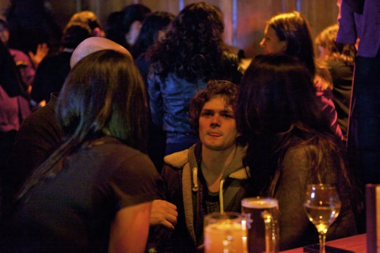 a man sitting at a bar next to others