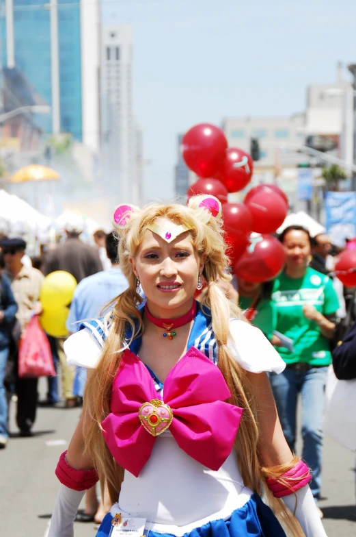 a woman dressed in an outfit and balloons and a bow