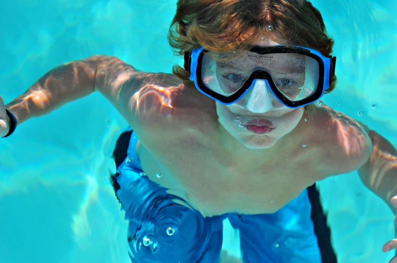 a  swimming underwater in a pool