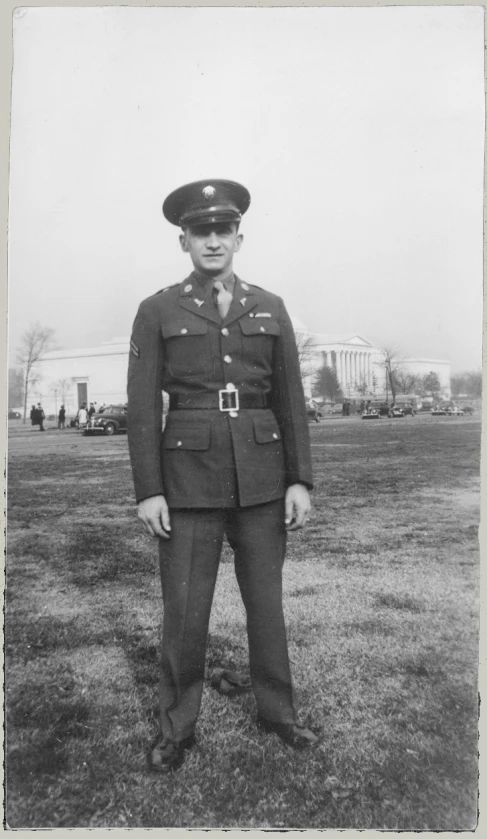 an older po of a man in uniform posing for the camera