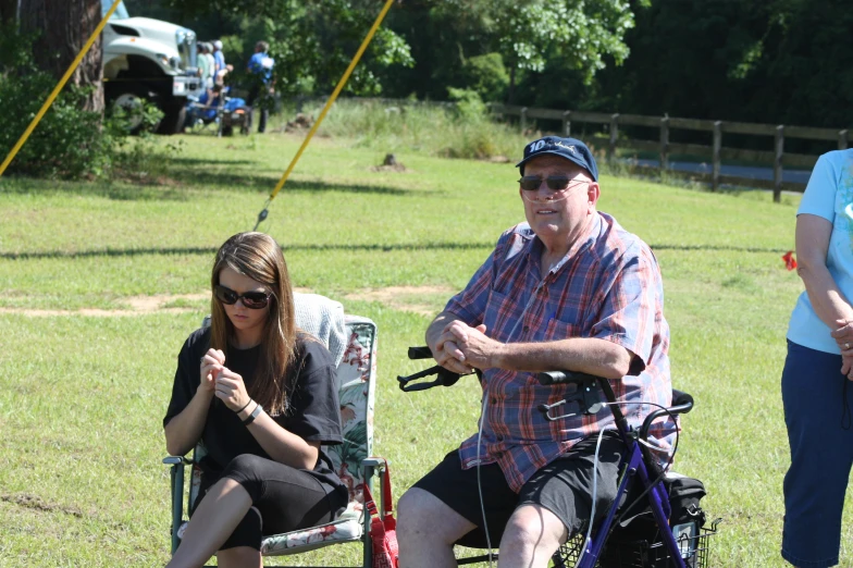 a man and a woman sitting on lawn chairs