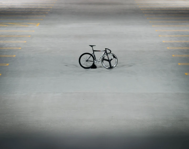 a bike is parked in the middle of a parking lot