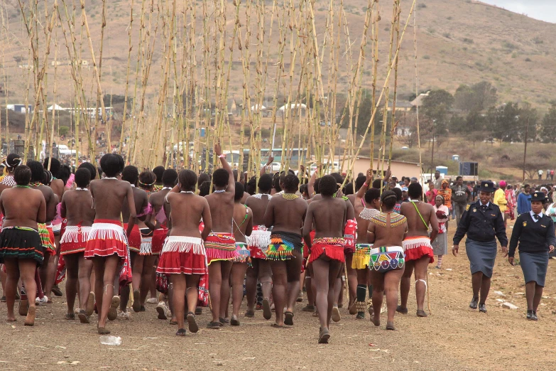 many people wearing skirts standing next to each other